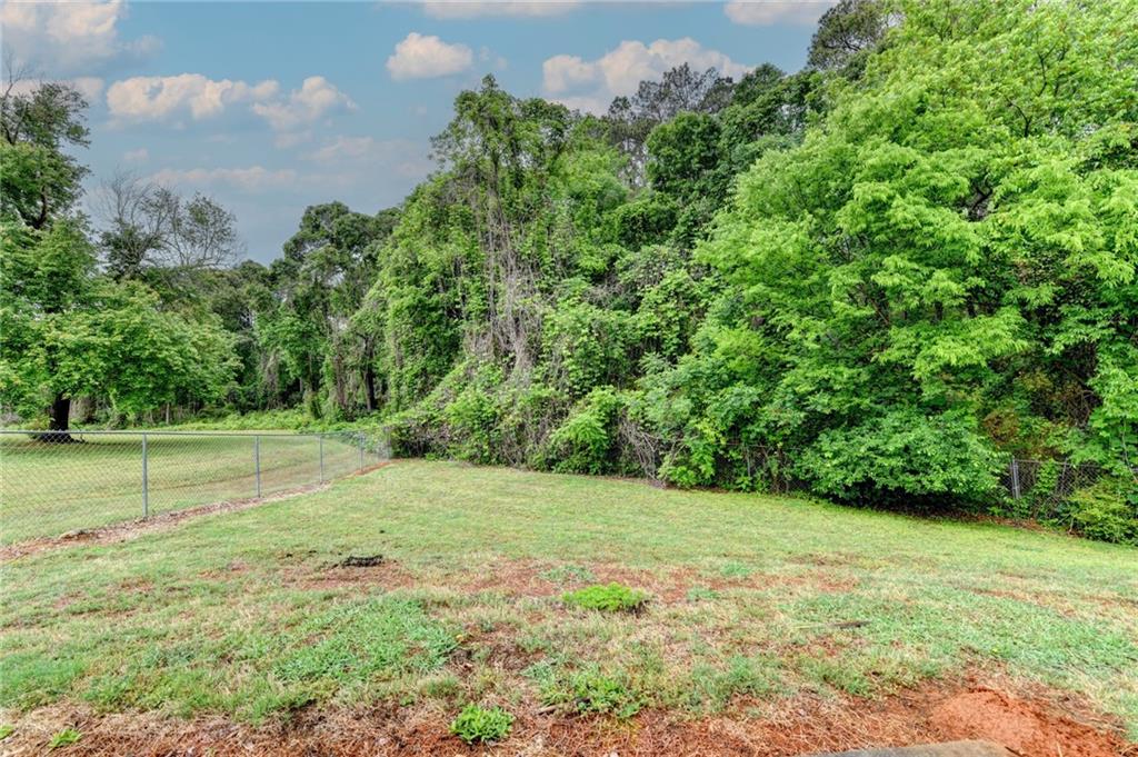 601 Bowling Lane Winder, GA 30680 - Photo 41 of 45 a view of a grassy field with trees in the background