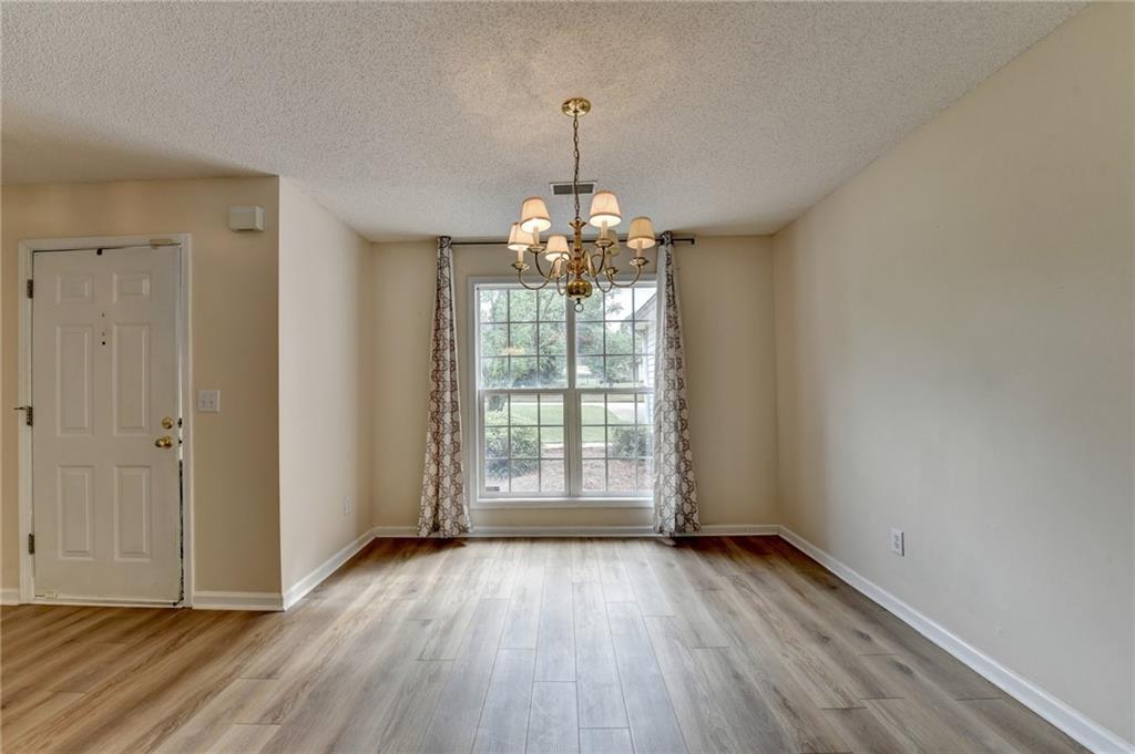 601 Bowling Lane Winder, GA 30680 - Photo 6 of 45 an empty room with wooden floor and windows
