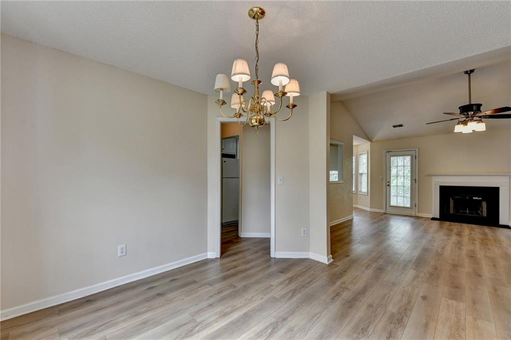 601 Bowling Lane Winder, GA 30680 - Photo 8 of 45 a view of a room with chandelier and wooden floor
