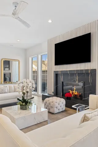 a living room with furniture flat screen tv and a fireplace