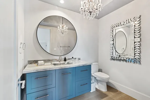a bathroom with a toilet a sink and a mirror