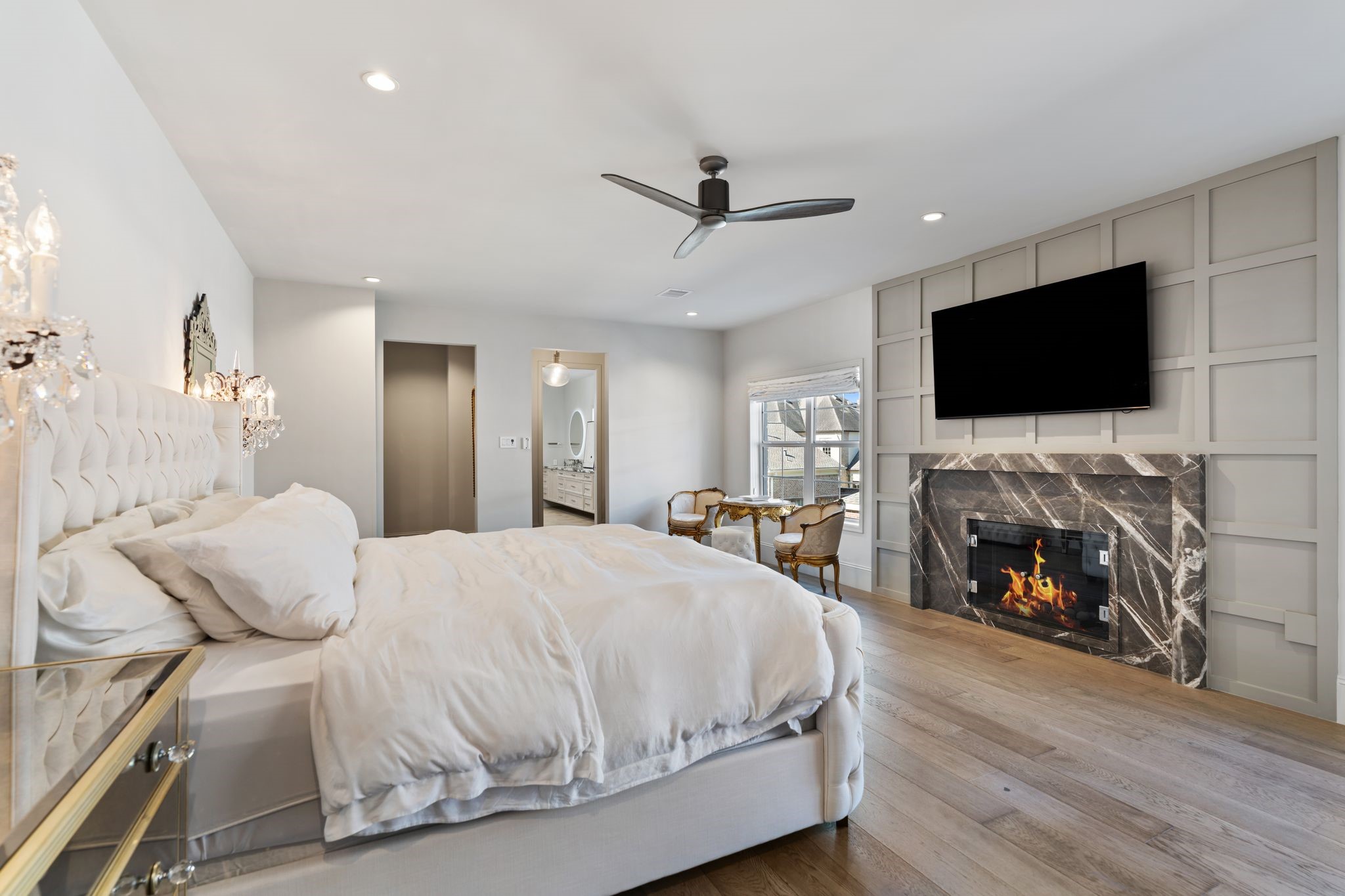 6012 Riverview Way Houston, TX 77057 - Photo 23 of 50 a spacious bedroom with a bed and a flat screen tv