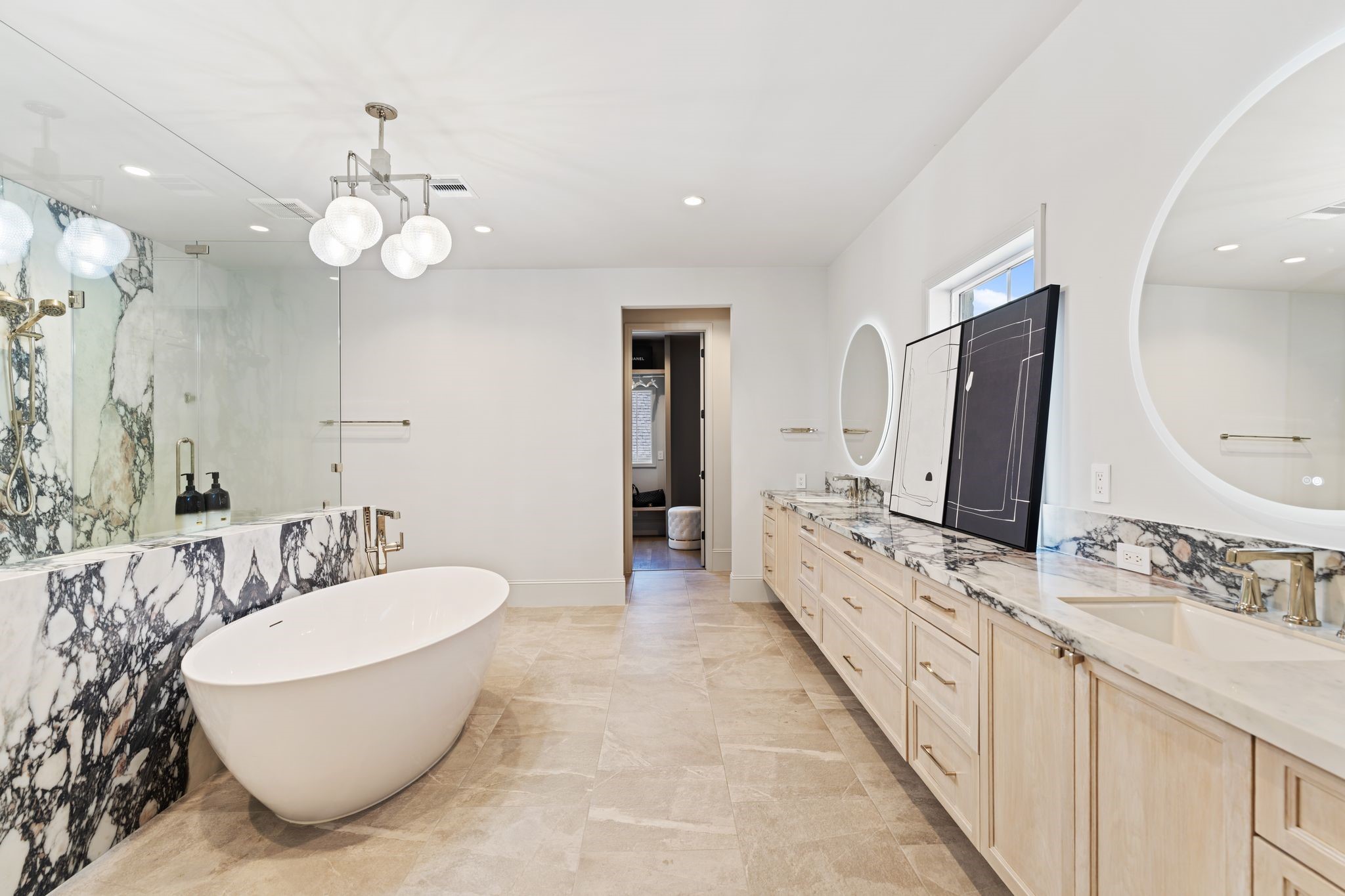 6012 Riverview Way Houston, TX 77057 - Photo 25 of 50 a bathroom with a double vanity sink a mirror and a bathtub