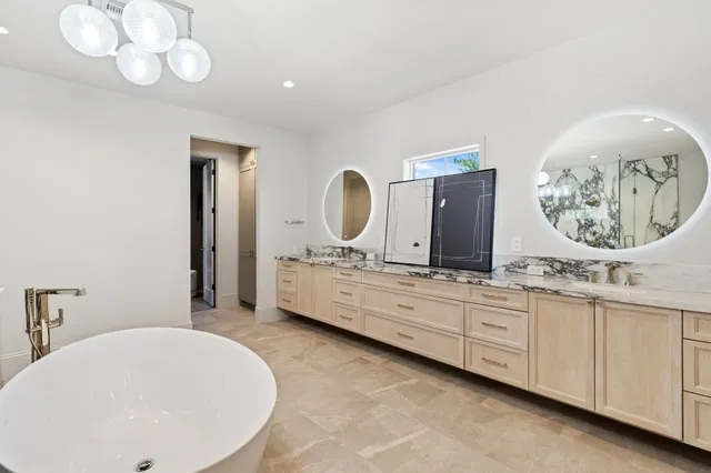a bathroom with a double vanity sink and a mirror