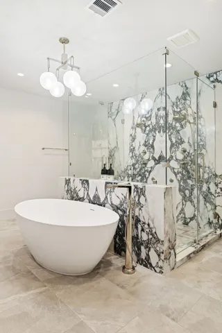 a spacious bathroom with a bathtub and shower