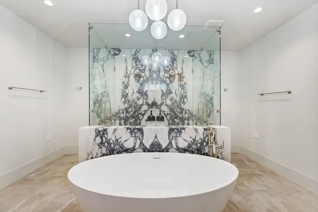 a bathroom with a bathtub and shower