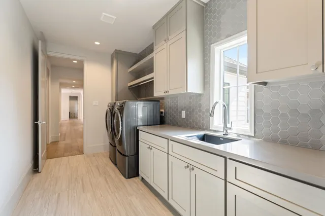 a kitchen with stainless steel appliances a refrigerator sink and cabinets