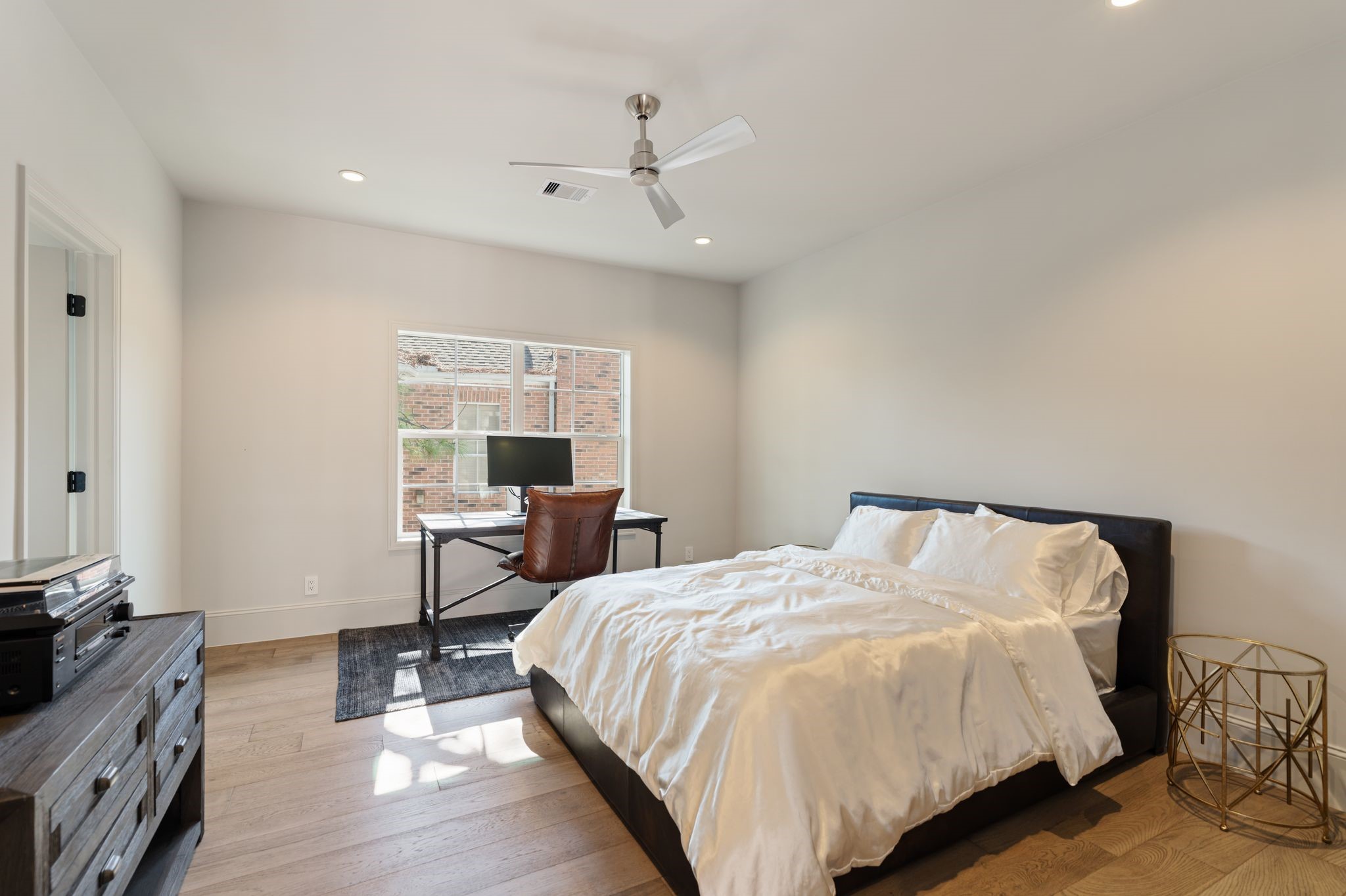 6012 Riverview Way Houston, TX 77057 - Photo 35 of 50 a bedroom with a bed and wooden floor