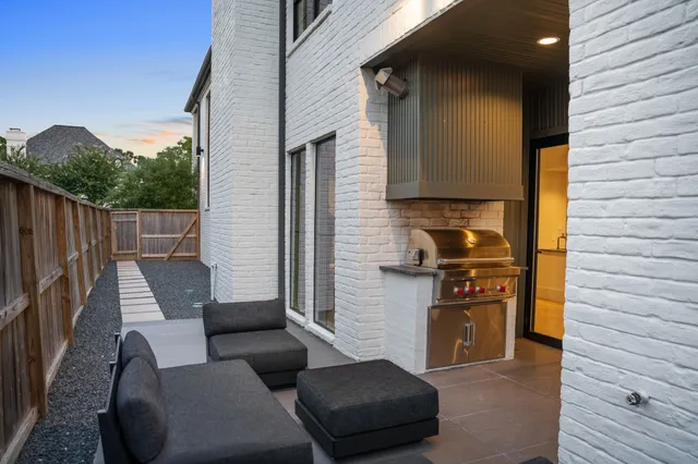 a view of a patio with couches chairs and wooden floor