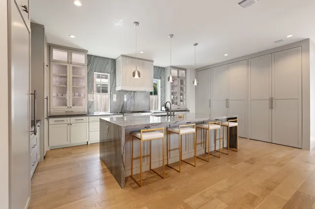 a large kitchen with kitchen island granite countertop a large counter top and sink