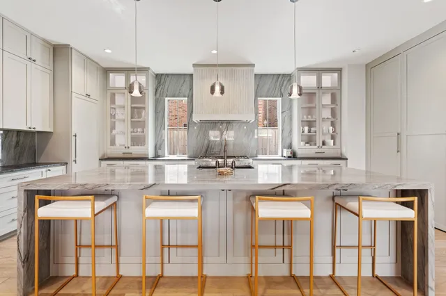 a kitchen with stainless steel appliances granite countertop a stove and cabinets