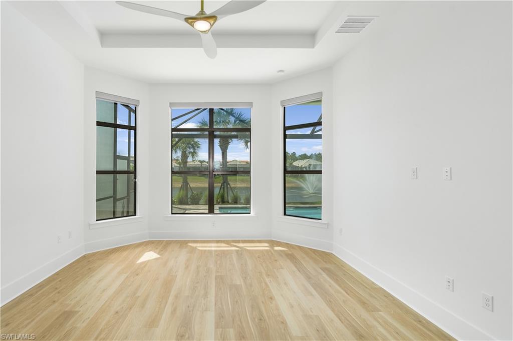 9560 Caymas Terrace Naples, FL 34114 - Photo 13 of 40 a view of an empty room with a window and wooden floor
