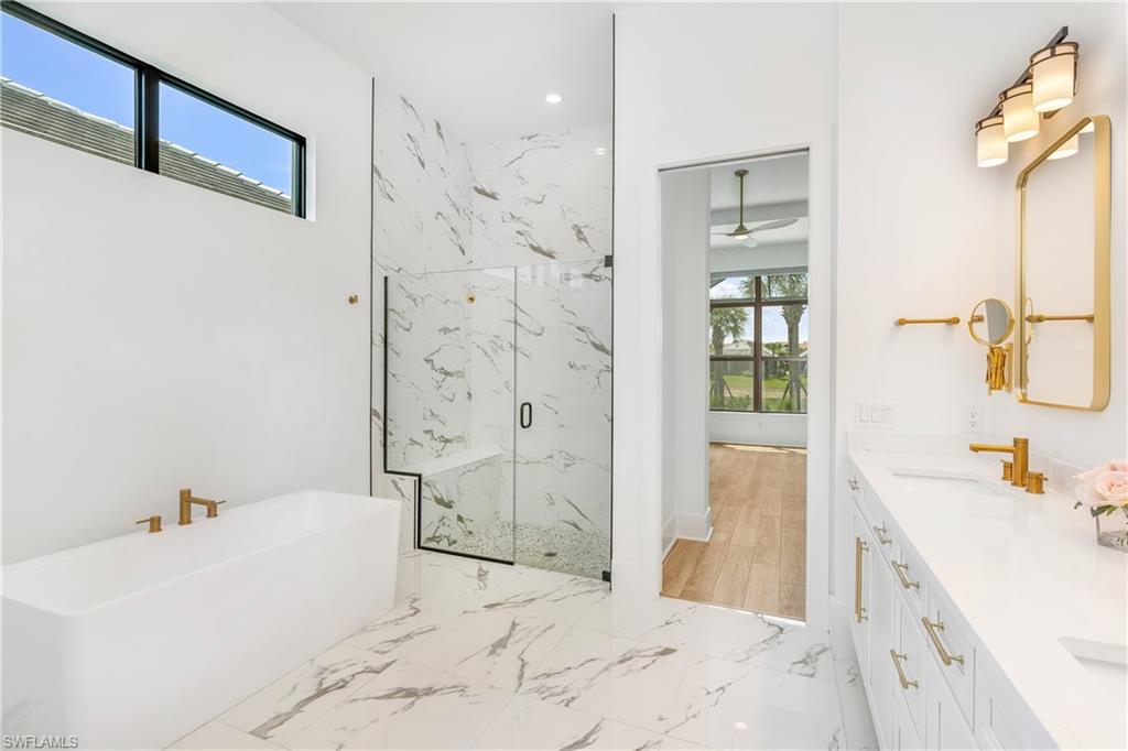 9560 Caymas Terrace Naples, FL 34114 - Photo 14 of 40 a spacious bathroom with a tub sink and shower