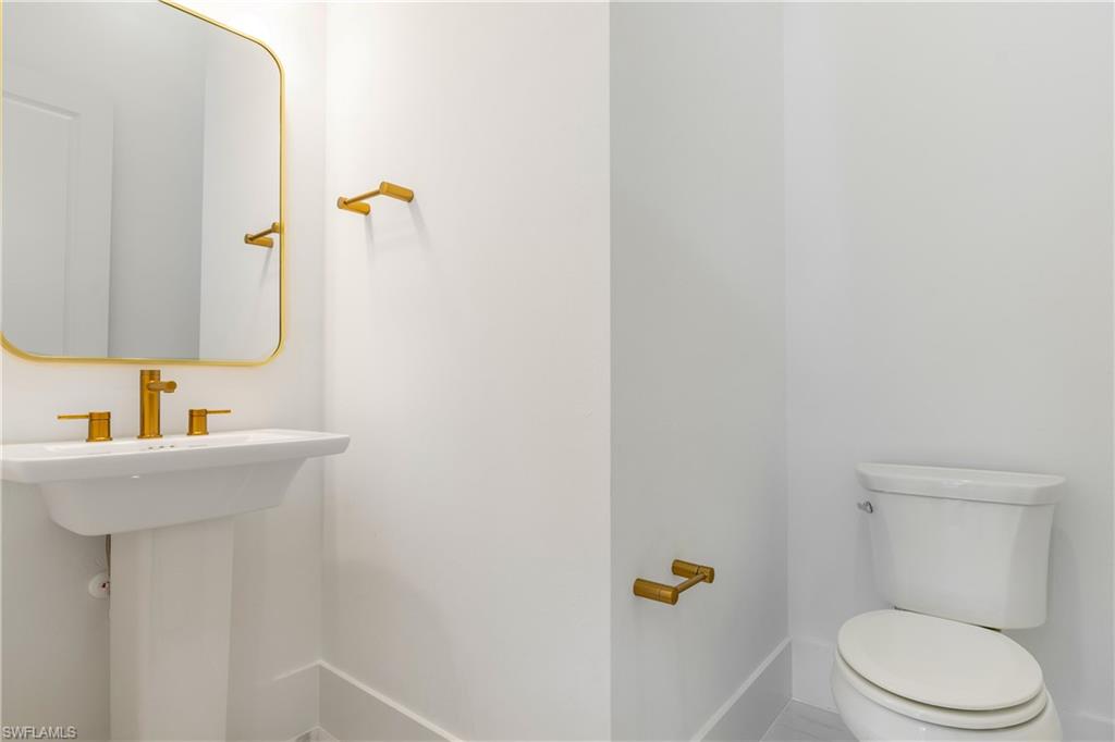 9560 Caymas Terrace Naples, FL 34114 - Photo 20 of 40 a bathroom with a sink a toilet and mirror