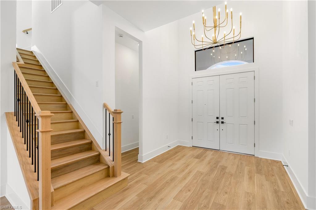 9560 Caymas Terrace Naples, FL 34114 - Photo 21 of 40 a view of a livingroom with wooden floor and entryway