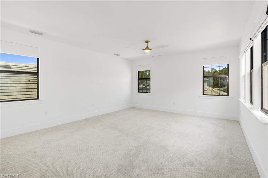 9560 Caymas Terrace Naples, FL 34114 - Photo 23 of 40 an empty room with windows and closet