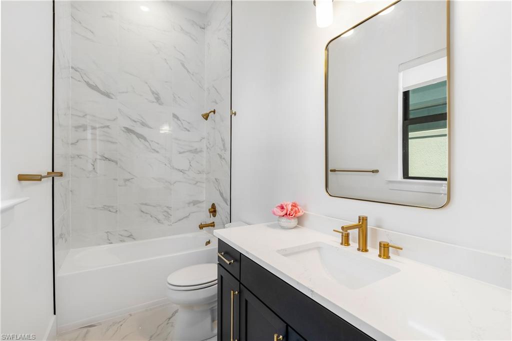 9560 Caymas Terrace Naples, FL 34114 - Photo 24 of 40 a bathroom with a sink toilet vanity and shower