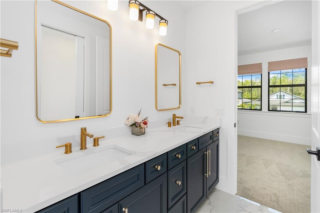 9560 Caymas Terrace Naples, FL 34114 - Photo 26 of 40 a bathroom with a sink double vanity and a mirror