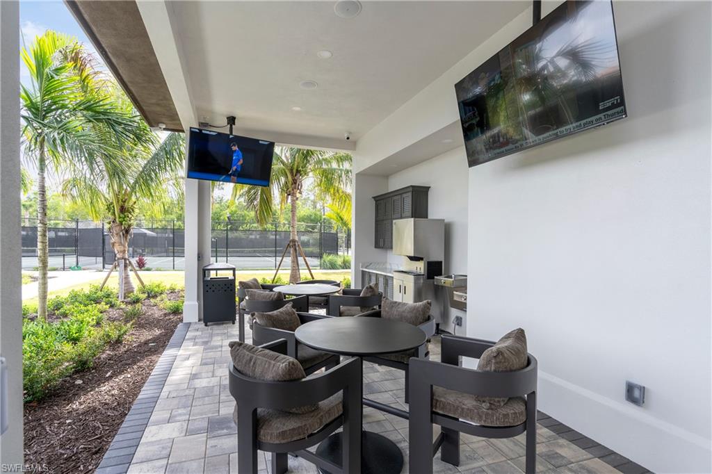 9560 Caymas Terrace Naples, FL 34114 - Photo 35 of 40 a living room with furniture and a flat screen tv
