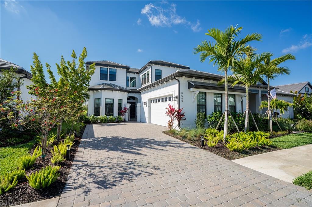9560 Caymas Terrace Naples, FL 34114 - Photo 39 of 40 a front view of a house with a yard and potted plants