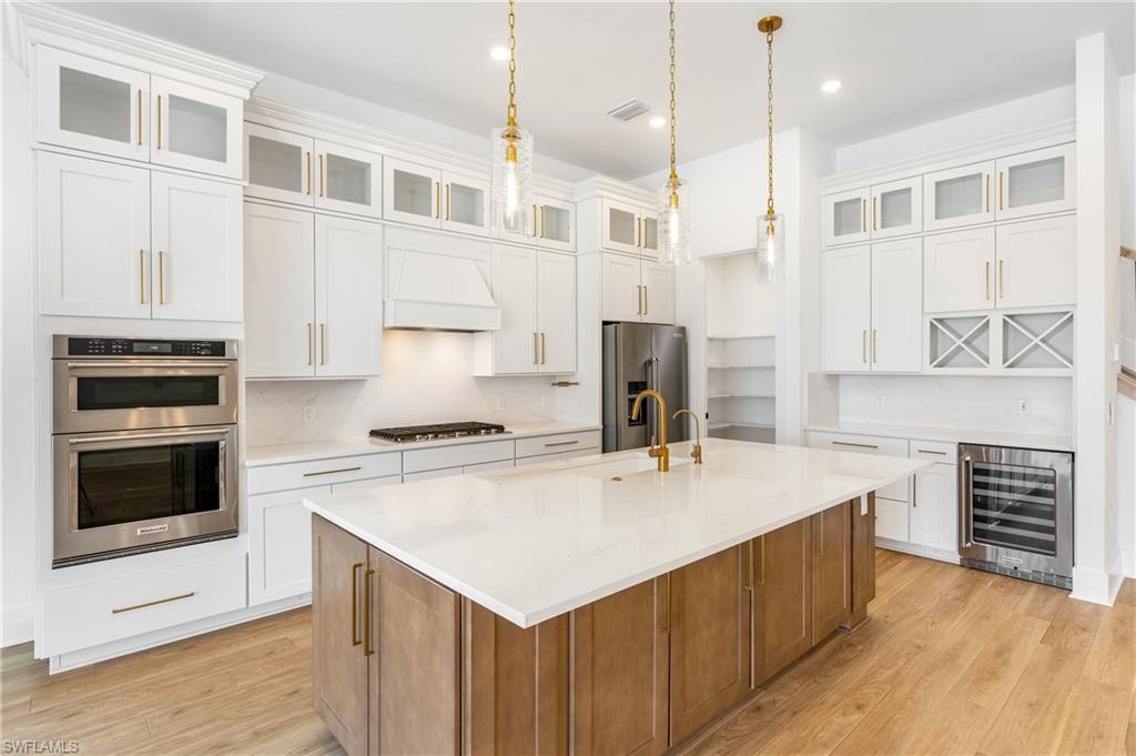 9560 Caymas Terrace Naples, FL 34114 - Photo 4 of 40 a kitchen with a stove a sink and a refrigerator