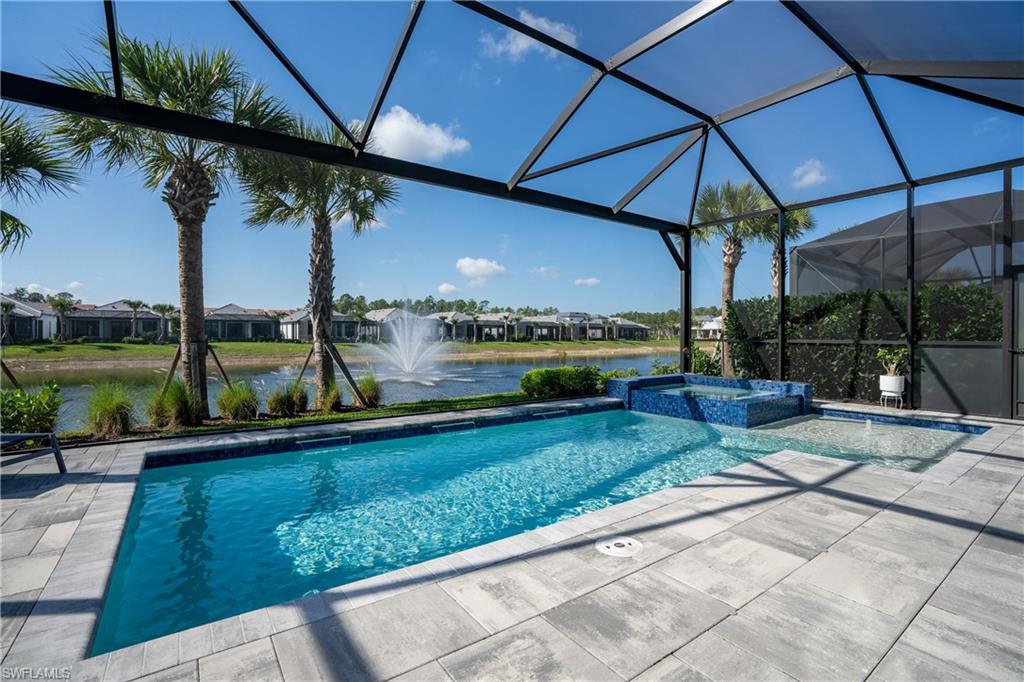 9560 Caymas Terrace Naples, FL 34114 - Photo 10 of 40 a view of a patio with a table and chairs under an umbrella
