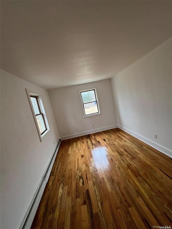 493 Munsell Road East Patchogue, NY 11772 - Photo 13 of 14 a view of empty room with wooden floor