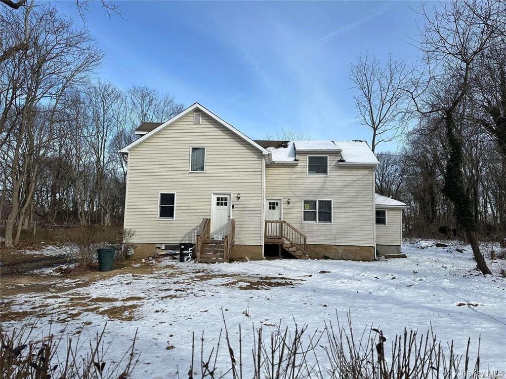 493 Munsell Road East Patchogue, NY 11772 - Photo 3 of 14 a front view of a house with a yard