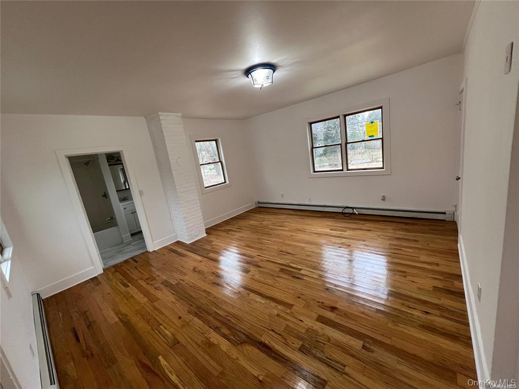 493 Munsell Road East Patchogue, NY 11772 - Photo 5 of 14 a view of empty room with wooden floor and fan