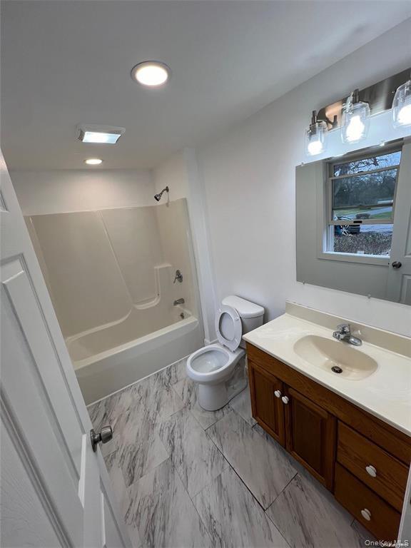 493 Munsell Road East Patchogue, NY 11772 - Photo 6 of 14 a bathroom with a sink and a mirror