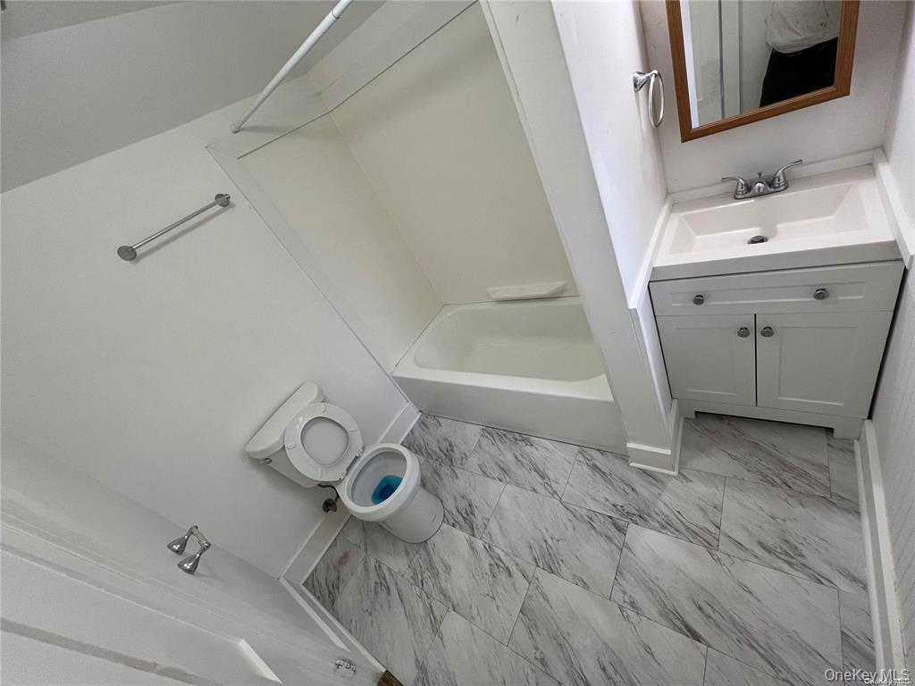 493 Munsell Road East Patchogue, NY 11772 - Photo 9 of 14 a bathroom with a sink and a mirror