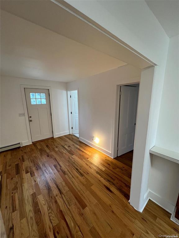 493 Munsell Road East Patchogue, NY 11772 - Photo 10 of 14 a view of empty room with wooden floor