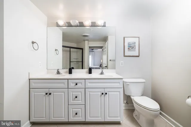 a bathroom with a toilet a sink and mirror
