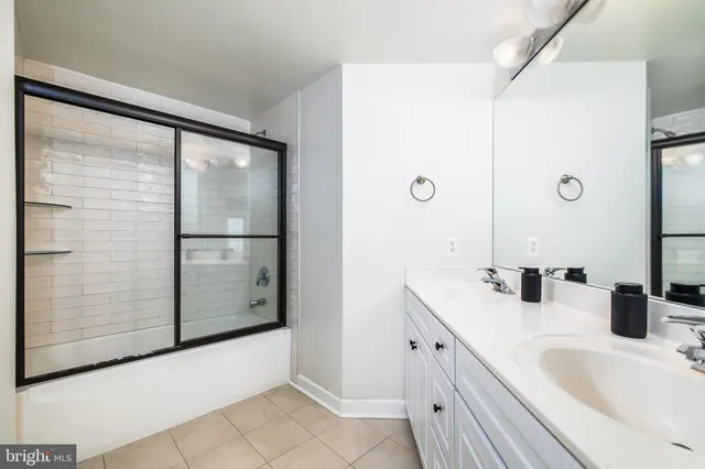 a bathroom with a double vanity sink and mirror