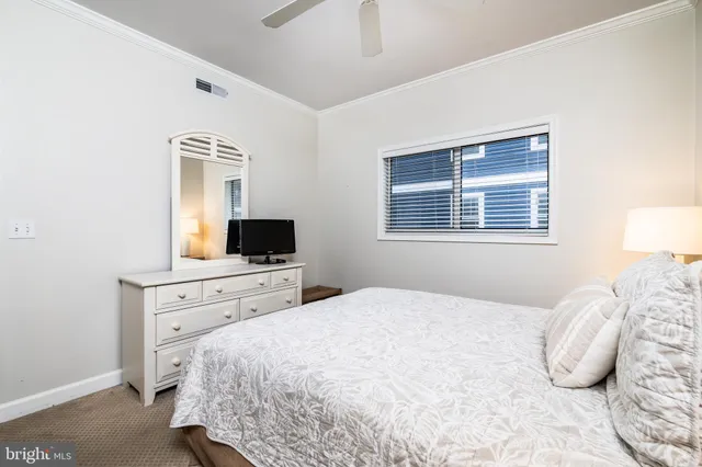 a bedroom with a large bed and a flat screen tv