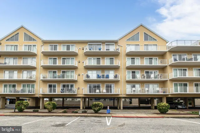 a front view of residential building and car parked