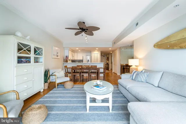 a living room with furniture a rug and white walls