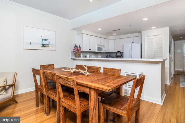 a view of a dining room with furniture and wooden floor