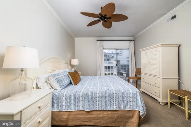 a bedroom with a bed a dresser and a large mirror