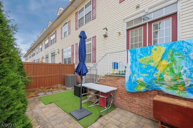 a view of a chair and table in the back yard of the house