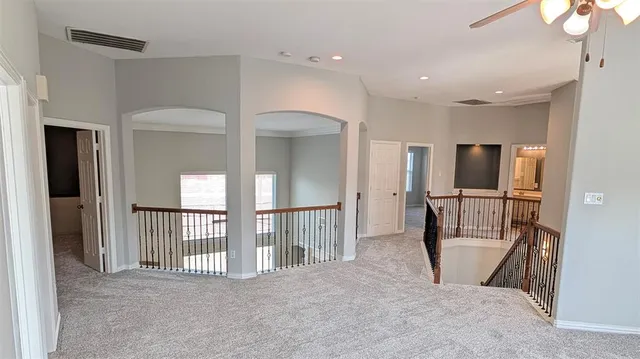 a view of a hallway view with wooden floor and staircase