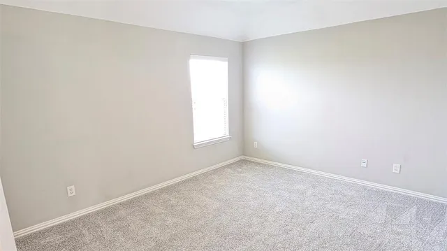 a view of a hallway with a livingroom and entryway