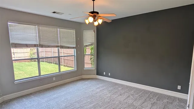 a kitchen with stainless steel appliances kitchen island granite countertop a stove a sink and a window