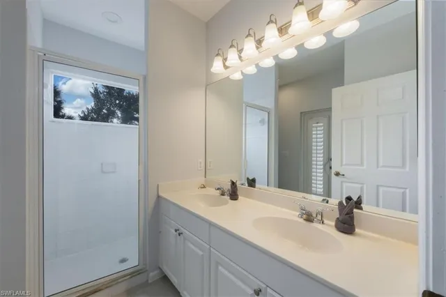 a bathroom with a double vanity sink and a mirror
