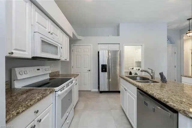a kitchen with granite countertop a sink and cabinets