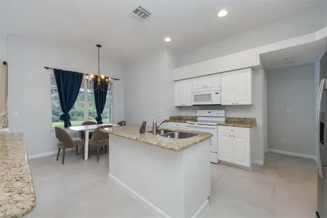 a kitchen with a sink stove and cabinets