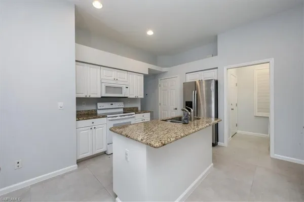 a kitchen with a sink stove and refrigerator