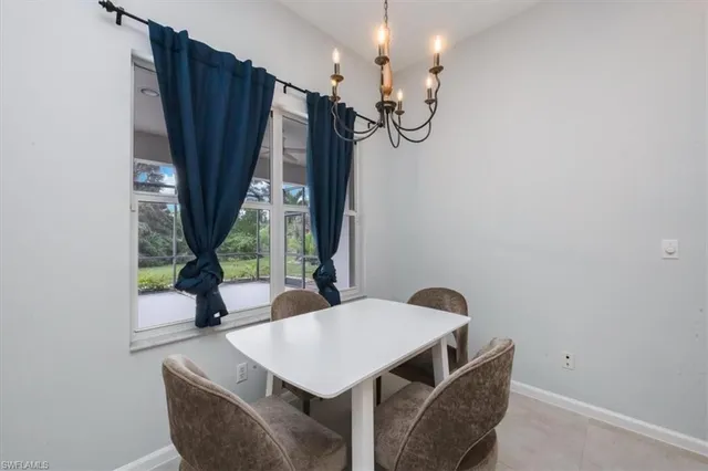 a view of a dining room with furniture and a window