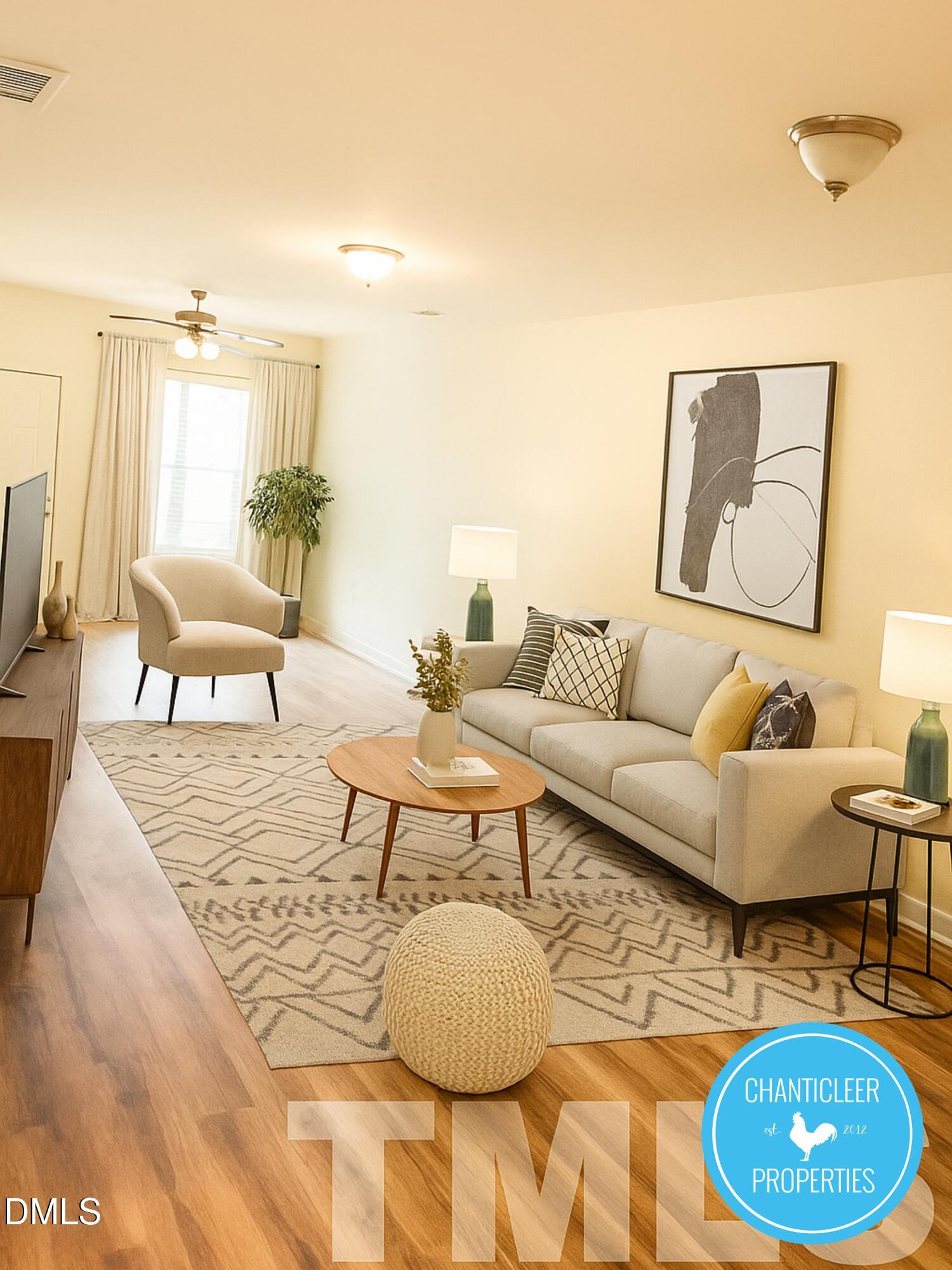 a living room with furniture a rug and a lamp