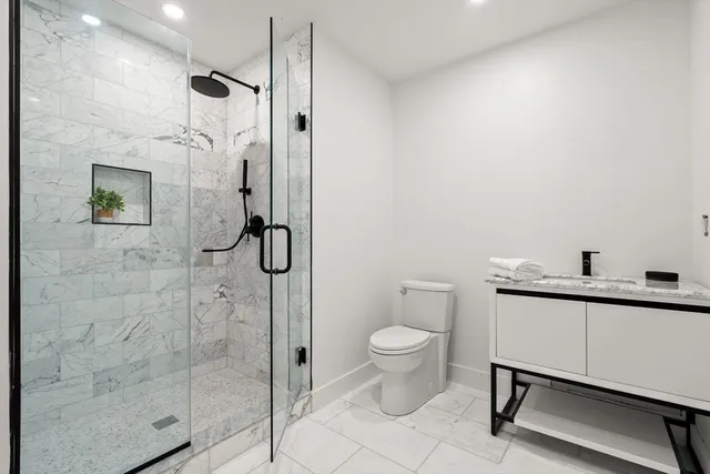 a bathroom with a toilet sink and a shower
